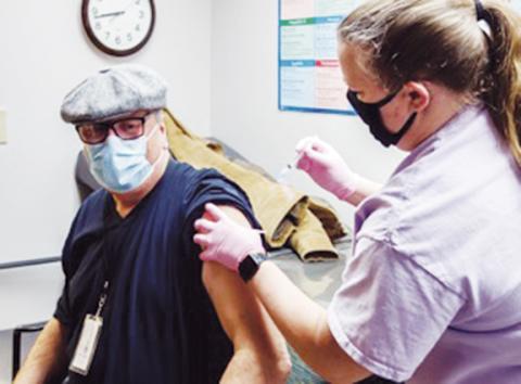 Sam Jokich of Murphy receives his first dose of the COVID-19 vaccine from nurse Misty Postell.