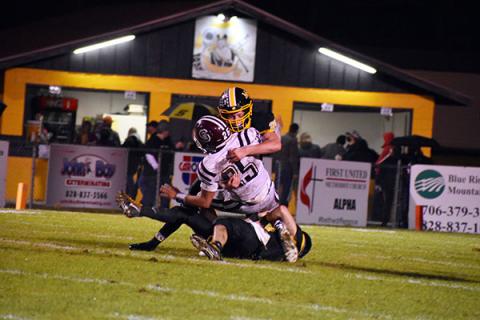 Murphys' John Ledford lays a hit on the Swain County quarterback.