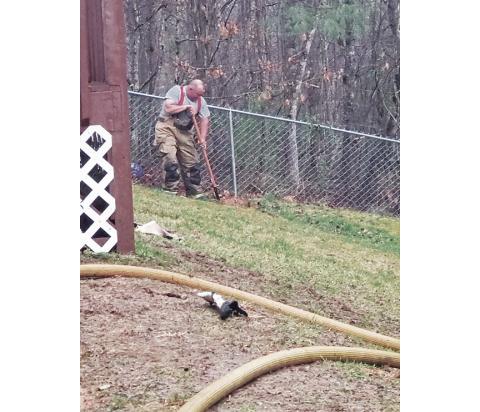Jason Berrong from the Ranger Volunteer Fire Department buries a puppy that died in a residential fire on Old Murphy Road on March 17.