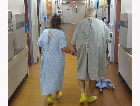 Jacky Egli (left) walks the halls of the Piedmont Transplant Center in Atlanta with her husband, Rich Egli, after giving him a kidney as a live donor.