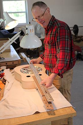 Stacy Van Buskirk/svanbuskirk@cherokeescout.com Mike Conner of Murphy tests the fit of the spider resonator cone in his handmade Dobro. It’s important that the parts fit snugly, not too tight, and the alignment is just right.
