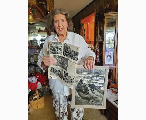 Photos by Stacy Van Buskirk/svanbuskirk@cherokeescout.com  Mary Ann Thompson, sister to Andrew Gaddis, holds the original Life magazine issue featuring his photo and a larger copy of the photo sent to the family. Gaddis was killed in action in 1951, leaving behind several medals in his all-too- brief military career 
