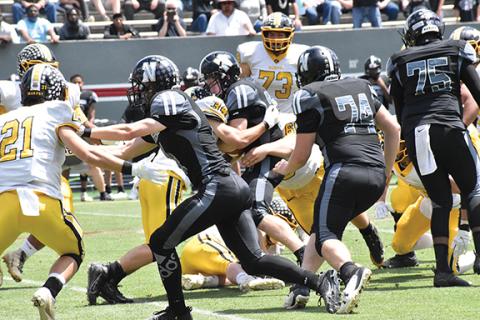 Photos by Justin Fitzgerald/sports@cherokeescout.com Murphy won the 1A state football championship game Saturday with gritty play in the trenches (left photo, with Ty Laney helping bring down a Northside-Pinetown running back) and with outstanding effort (right photo, with a Bulldog player giving 100 percent to dive for a loose ball).