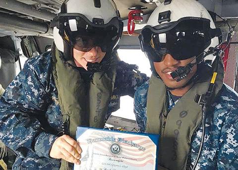 Murphy High School graduate Greg Lloyd does his re-enlistment in a helicopter over Tokyo. “You are discharged, then sign a new contract,” the Navy Blue Angel said.
