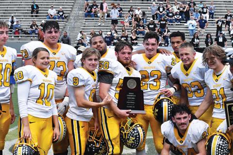 Justin Fitzgerald/sports@cherokeescout.com Seniors Landon Jordan and Ray Rathburn admire the state 1A championship trophy as other seniors join the celebration after Murphy’s 14-7 win over Northside-Pinetown.