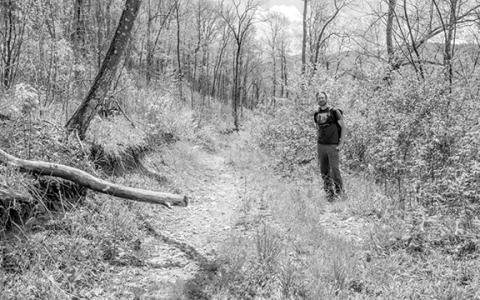MountainTrue public lands biologist Josh Kelly stands next to a “temporary road” built in 2012 in Nantahala National Forest.