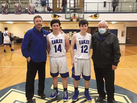 Photos by Dana Dockery/Contributing Photographer Jeremiah Dockery, No. 12, with his twin brother, Jacob, along with Hiwassee Dam High School Eagles varsity basketball coaches Mark Raper (left) and Leon Green.