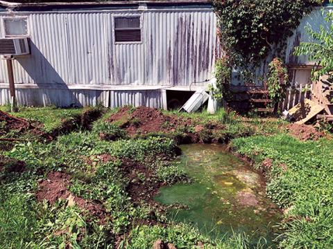 Penny Ray/pennyray@cherokeescout.com  A small pond of sewage has formed directly behind a trailer at Sherrill Mobile Home Park in Andrews.