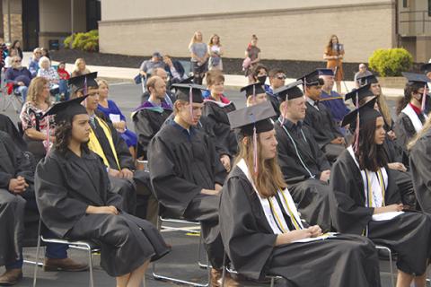 Tri-County Early College High School graduate Sterling Hardin and other graduates return to their seats after receiving their diplomas at the school’s commencement ceremony Saturday morning. This year’s Early College class numbered 31 students. 