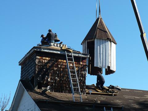 Wally Avett/Cherokee Scout Workers with a crane lifted off the Harshaw Chapel steeple just before Christmas in 2019 and covered the leaking roof with a waterproof plastic film.