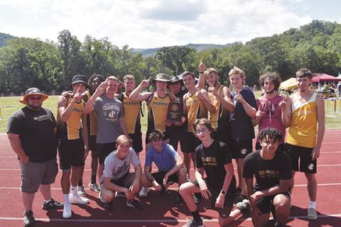 Photos by Justin Fitzgerald/sports@cherokeescout.com  The Murphy boys track and field team celebrates Friday with the championship roster on the road in Cherokee.