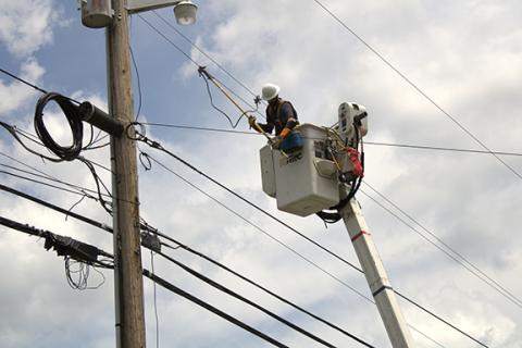 Charlie Benton/cbenton@cherokeescout.com Blue Ridge Mountain Electric Membership Corp. crews work to restore power after several lines fell across U.S. 64 West in Ranger on Friday. 