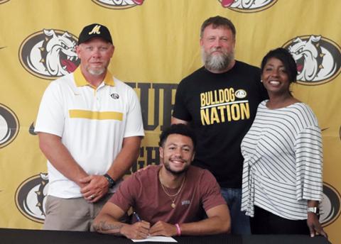 Dana Anderson/Contributing Photographer Murphy alum Abram Abling signed to basketball at Pfieffer on June 7. Pictured behind Abling (from left) are boys basketball head coach Eric Laney and his parents