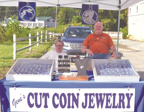 Gene Russell and his wife with his coin collection.