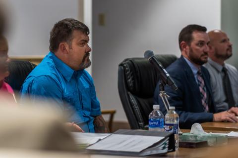 From left, Christopher Drew Hill listens to testimony in court alongside assistant district attorney Caleb Decker and Graham County sheriff’s Deputy Matt Cox. 