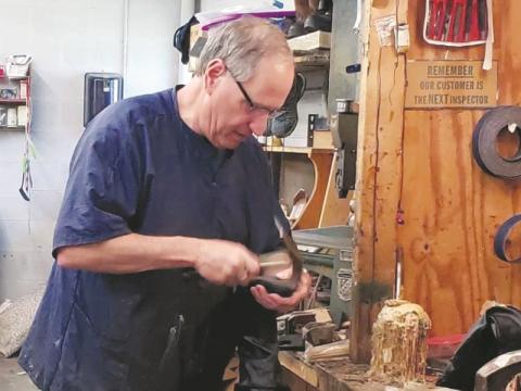 Dillon Gibson of Andrews repairs shoes at his family business. His grandfather started the business in 1928, and Gibson hopes to keep it going until the 100th anniversary. 