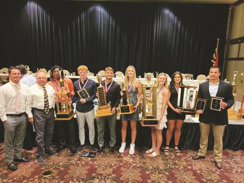 Murphy football coach Joseph Watson, former football coach David Gentry, Juan Allen, Payton McCracken, Kellen Rumfelt, Torin Rogers, Lochlan Rogers, Sarah Pullium and girls basketball head coach Ray Gutierrez (from left) pose with the Bulldogs’ awards from the 59th annual WNC Sports Banquet.