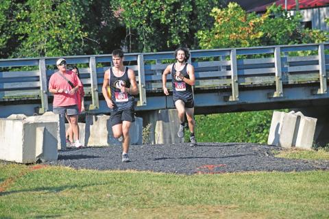Murphy’s Clayton Laney and Caleb Rice are the first two to near the finish line in the high school boys 5K at the Murphy Invitational on Saturday.