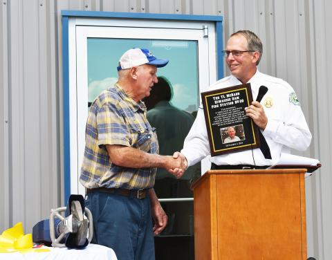 Fire Chief Chad McNabb (right) dedicates the new Hiwassee Dam Volunteer Fire Department on Saturday to TL McNabb, who served the department for 45 years.