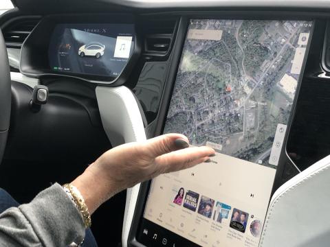 Margaret Keenum-Ackiss demonstrates the technology inside her electric vehicle. 