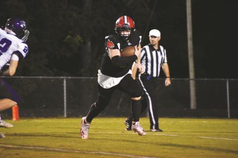Andrews junior Austin Martin carries the ball during the Wildcats’ 26-14 win over Mitchell on Sept. 10.