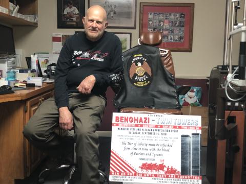 Dr. Dan Eichenbaum with his memorial sign and riding clothes.