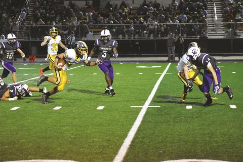 Murphy’s Ty Laney eludes one would-be tackler and prepares to get by another during the Bulldogs’ 54-24 win over Union County on Friday.