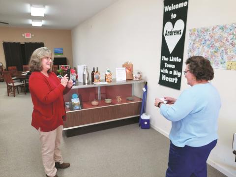 Executive Director Nola Cooper and President Gayle Horton Chamber pull names of raffle entries for prizes during the Andrews Chamber of Commerce’s open house Saturday.