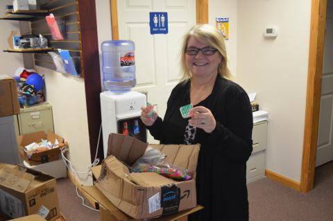 Executive Director Cecilia Crawford organizes items for Reach’s School Program.