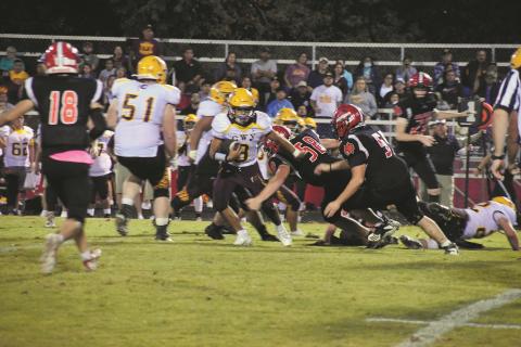 Andrews Dalton Rose (55) and Harley Crawford (58) look to bring down Cherokee running back Michael Driver during the Braves 12-9 win over the Wildcats on Oct. 15.