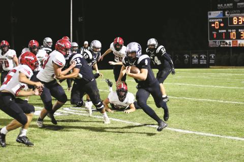 Andrews Cole Anderson (85) and Drew Martin (53) try to cut off the angle of Robbinsville’s Cuttler Adams during the Black Knights 24-14 win over the Wildcats on Friday.