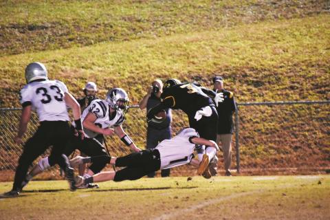 Murphy’s Payton McCracken is tackled by Robbinsville’s Zeke Silvers during the Bulldogs’ 23-20 loss to the Black Knights on Friday. 