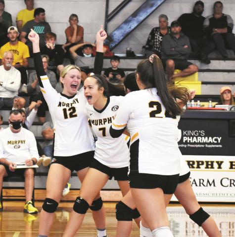 Murphy’s Lailee Holloway (7) and Lochlan Rogers (12) celebrate Holloway’s first varsity kill during the Lady Bulldogs’ 3-0 win over Blue Ridge Early College on Saturday. It was Holloway’s first match after being pulled up from the junior varsity.