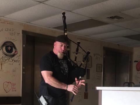 Bill Higgins plays the bagpipes to stir up the spirits for the Cherokee County Paranormal Society.