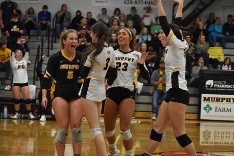 From left, Murphy’s Cailey Dockery, Cali Rumfelt, Olivia Payne, Maddison Seabolt celebrate a play during the Lady Bulldogs’ four-set win over Uwharrie Charter on Saturday.