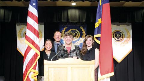 Abigail Hickman/Staff Correspondent Freshman Iris Diaz, Principal Jason Forrester, senior Isaac Jenen and sophomore Cameron Woody prepare for the Veterans Celebration on Friday at Tri-County Early College.