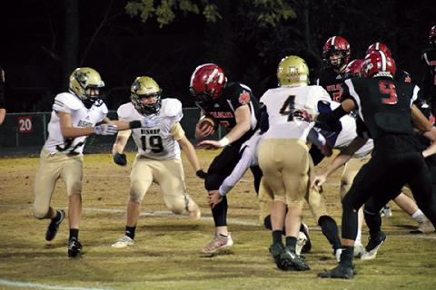 Photos by Justin Fitzgerald/sports@cherokeescout.com Austin Martin of Andrews tries to run by a group of Villains during the Wildcats’ 34-6 win Friday night over Bishop McGuinness in the state 1A playoffs. Andrews travels to Starmount for this week’s playoff game.