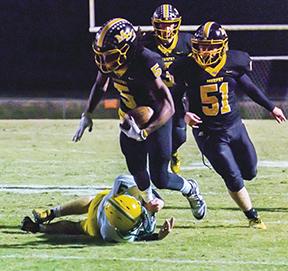 Sam Jokich/Staff Correspondent Murphy’s Juan Allen wriggles free from an Alleghany defender during the Bulldogs’ 58-20 win over the Trojans on Friday night.