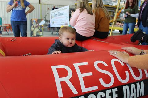Cade Matheson plays in a rubber rescue boat during Hiwassee Dam’s open house. 