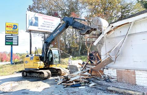 Jared Putnam/Clay County Progress Workers tear down the Big D Convenience Store at Old Highway 64 on Nov. 2 in Hayesville. The company will soon move into a larger building directly behind the old facility. The building housed Hilltop Store in the 1960s.