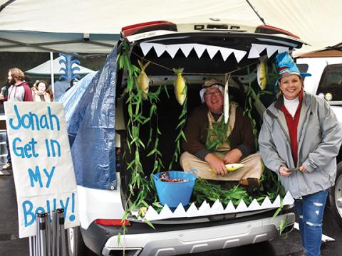 Bob and Temple Weinkle tell the story of Jonah and the whale while passing out treats.