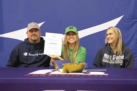 Murphy volleyball player Cailey Dockery flashes a big smile after signing a national letter of intent to play at the University of Notre Dame. From left are her father, Chris; Cailey Dockery; and her mother, Tina Dockery.