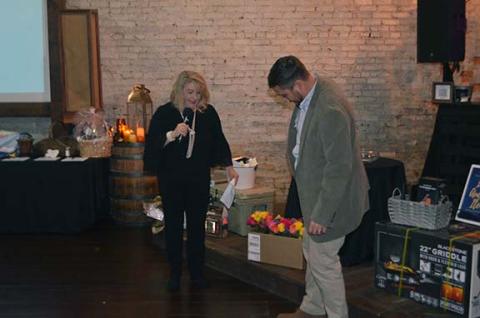 Photos by Abigail Hickman/Staff Correspondent Cherokee County Schools Superintendent Jeana Conley watches as teacher Michael Kernea steps on a $20 bill.