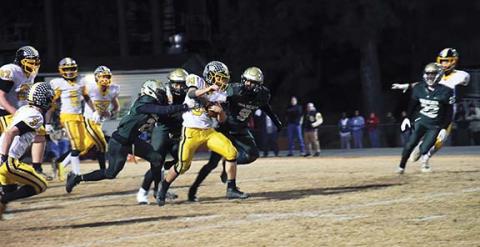 Justin Fitzgerald/sports@cherokeescout.com Murphy running back Ty Laney tries to shed Eastern Randolph defenders during the Bulldogs’ 64-31 win over the Wildcats on Friday night.