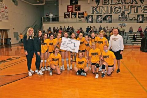 David Guffey/Contributing Photographer  The Murphy junior varsity volleyball team celebrates after winning the Smoky Mountain Conference Tournament. Front row (from left): Addie Johnson, Kinslie Campbell, Julia Dockery and Aiden Smith. Back row (from left): Coach Jordan Lovingood, coach Amanda Johnson, Cayla Geer, Ellie Dockery, Anna Brinke, Addyson Dickey, Jayda Holley, Lailee Holloway, Raegan Curtis, Wyndsor Caldwell, Carsyn Lovingood and coach Keith Holloway.