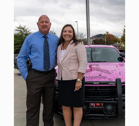 District Attorney AshleyWelch stands in front of the car beside Henderson County Sheriff Lowell Griffin.