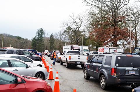 Abigail Hickman/Staff Correspondent Parents patiently snake though the Toys for Tots giveaway line Friday in Peachtree.