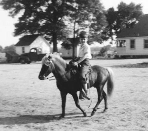 Author Wally Avett at elementary-school age is shown exercising a neighbor’s pony, without the Western hats and boots he would favor later.