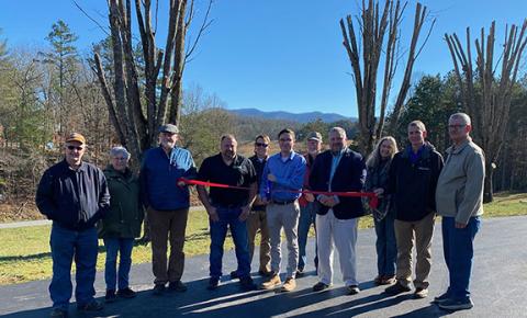 Blue Ridge Mountain Electric Membership Corp. personnel, Clay County officials and the first area fiber internet service customers celebrate with a ribbon-cutting ceremony in the parking lot of Pine Log Baptist Church on Jan. 4.