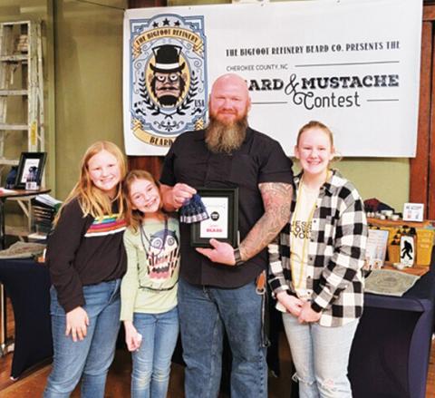 Abigail Hickman/Staff Correspondent Heath Woodard – with daughters Breana, Brooklyn, Bailee and Breana – claims first prize in the beard contest.